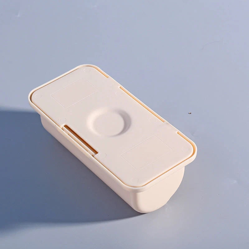 Wall-mounted plastic garbage bag holder in white, grey, and pink for kitchen organisation