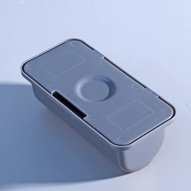 Wall-mounted plastic garbage bag holder in white, grey, and pink for kitchen organisation