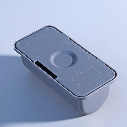 Wall-mounted plastic garbage bag holder in white, grey, and pink for kitchen organisation