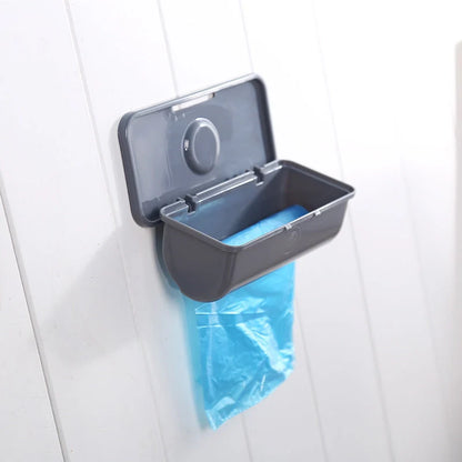 Wall-mounted plastic garbage bag holder in white, grey, and pink for kitchen organisation