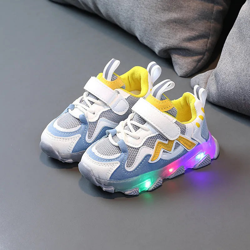 Kids' black breathable mesh sneakers with Velcro straps and a rubber sole on a white background.