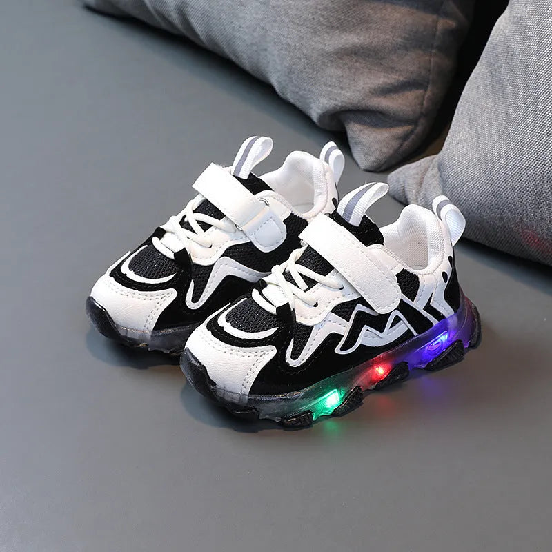 Kids' black breathable mesh sneakers with Velcro straps and a rubber sole on a white background.