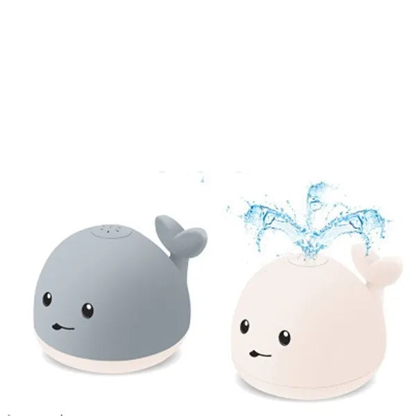 Grey and white cartoon whale bath toy spraying water with LED lights glowing