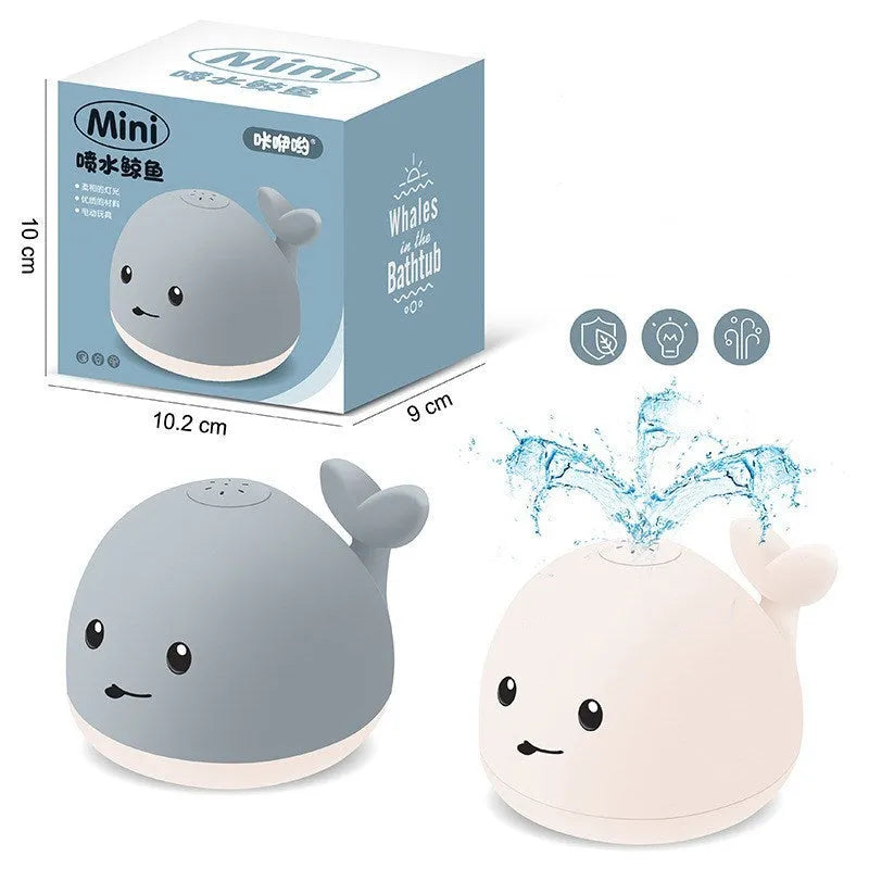 Grey and white cartoon whale bath toy spraying water with LED lights glowing