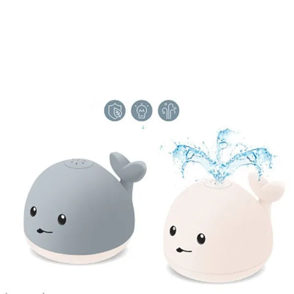 Grey and white cartoon whale bath toy spraying water with LED lights glowing