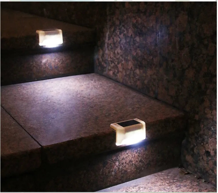 White shell solar-powered LED railing light with IP65 waterproof rating for outdoor steps.