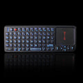 Black wireless mini keyboard with integrated touch screen and optical mouse, showing compact size.
