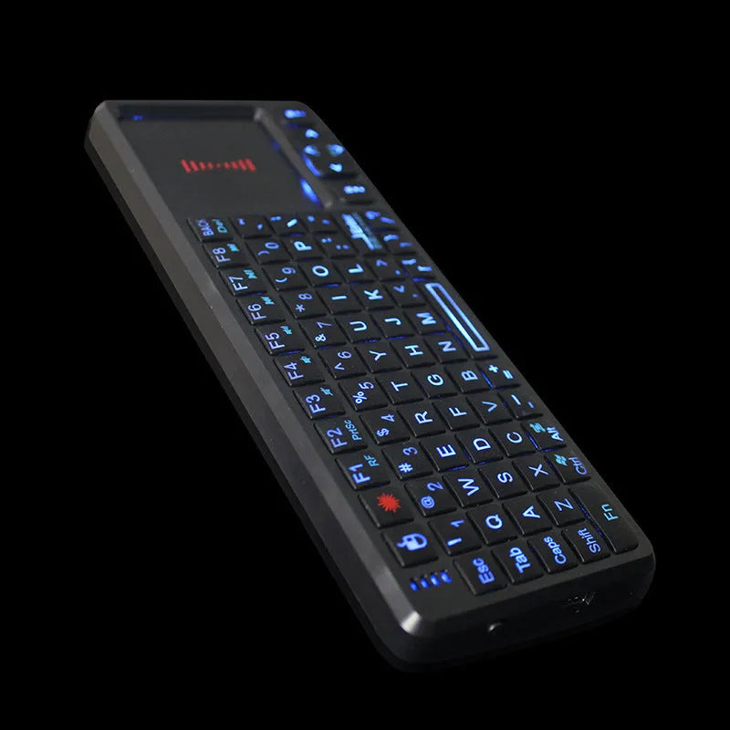 Black wireless mini keyboard with integrated touch screen and optical mouse, showing compact size.