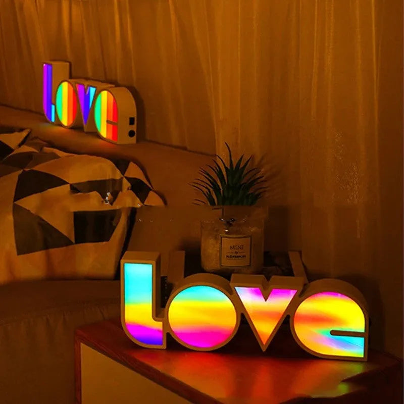 LOVE Colorful LED Letter Night Light with PVC shell showing purple illumination on a desk