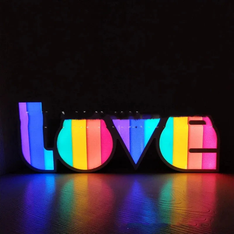 LOVE Colorful LED Letter Night Light with PVC shell showing purple illumination on a desk