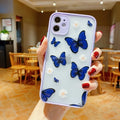 Pink acrylic iPhone case with a butterfly design and soft coloured edges.