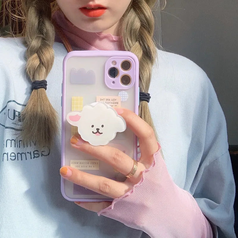 Frosted painted TPU mobile phone case with a built-in folding bracket, shown in a cartoon design for Apple iPhone.