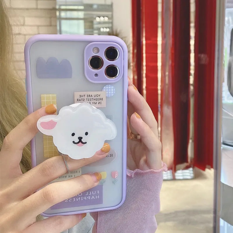 Frosted painted TPU mobile phone case with a built-in folding bracket, shown in a cartoon design for Apple iPhone.