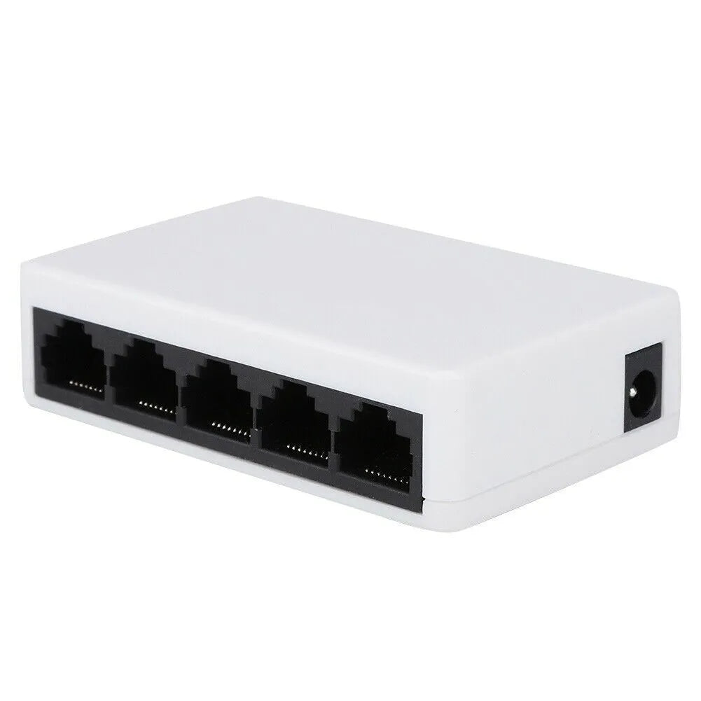 White 5-port 100 Mbps Ethernet switch with LED indicators on a desk