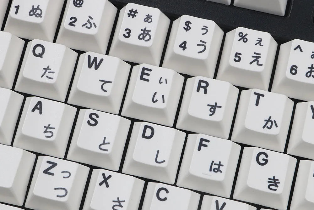 Black and white Japanese minimalist sublimation keycap set with 104 PBT keycaps in original factory height on a flat surface.