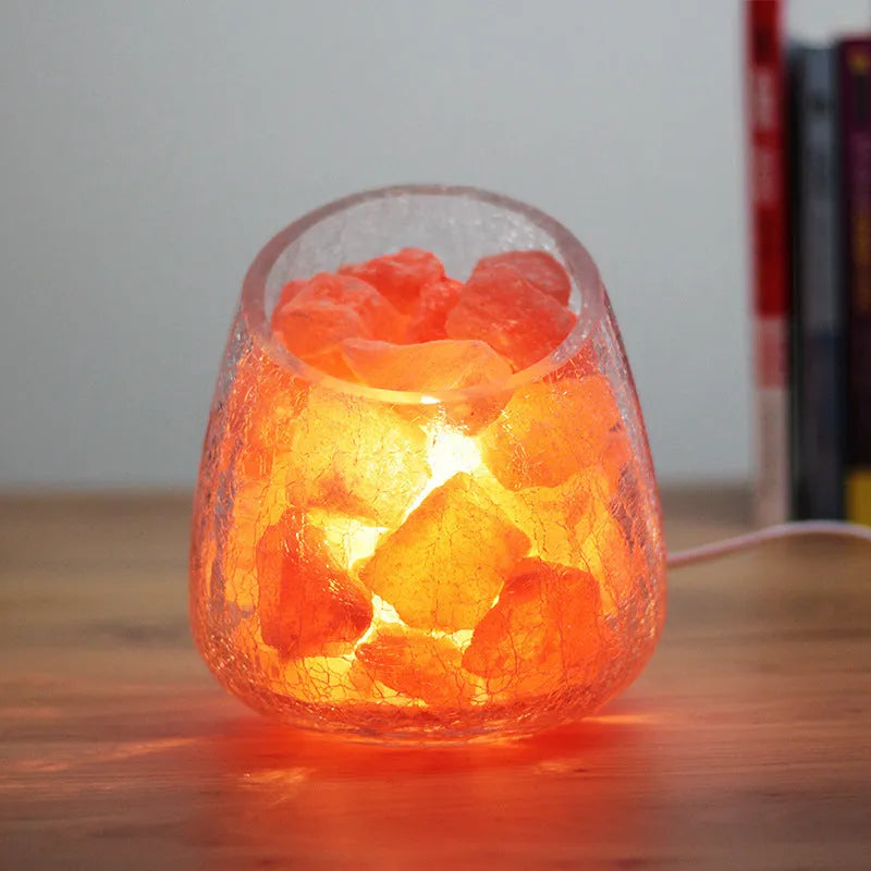Crystal salt lamp night light with warm 10W glow, glass oblique mouth ice crack shade, 130mm x 140mm, on bedroom table