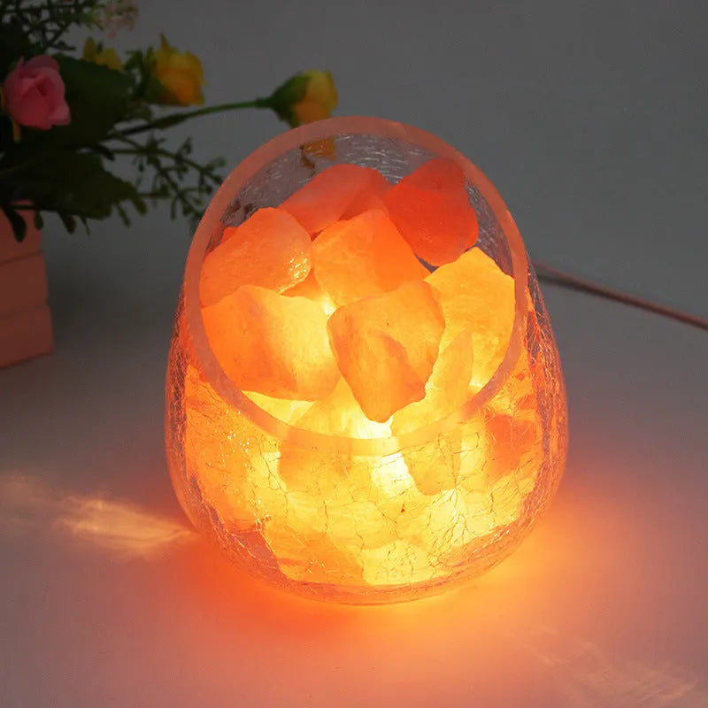 Crystal salt lamp night light with warm 10W glow, glass oblique mouth ice crack shade, 130mm x 140mm, on bedroom table