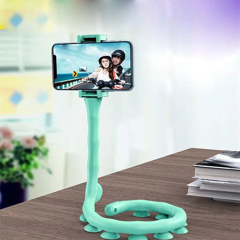 Black flexible arm phone holder with suction cup mounted on a desk, showing 360° rotation.