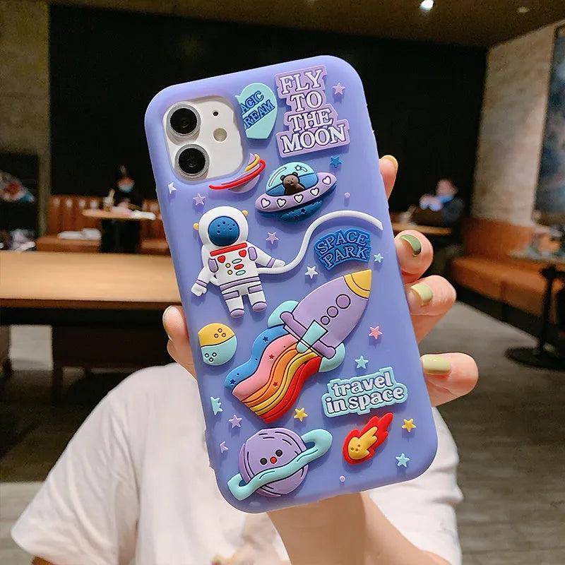 Purple silicone iPhone case with cartoon astronaut spaceman design showing precise port cut-outs