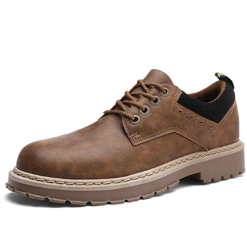 Men's black casual shoes with a round toe and flat rubber sole on a plain background