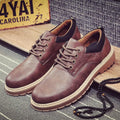 Men's black casual shoes with a round toe and flat rubber sole on a plain background