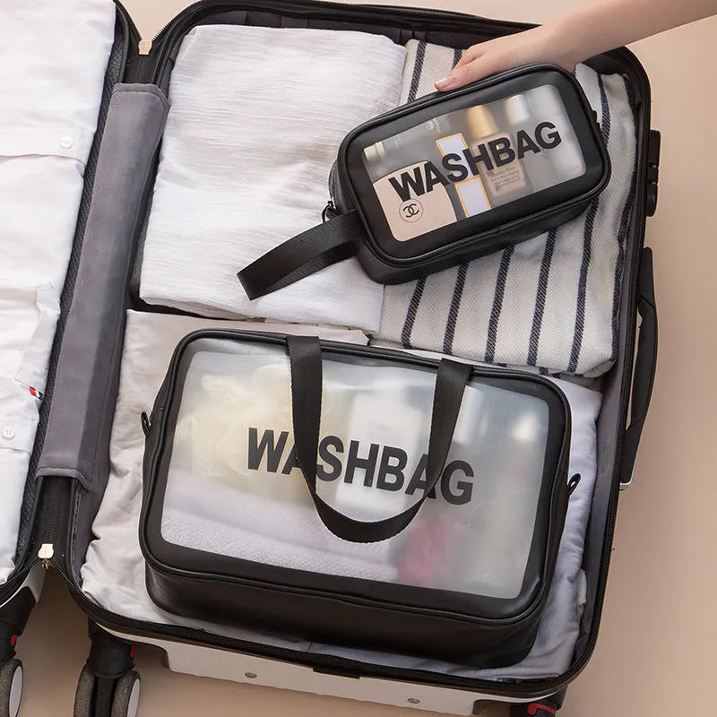 Korean transparent PU waterproof cosmetic bag in cherry pink, medium size, on a white background, showing its cube shape and zip closure.