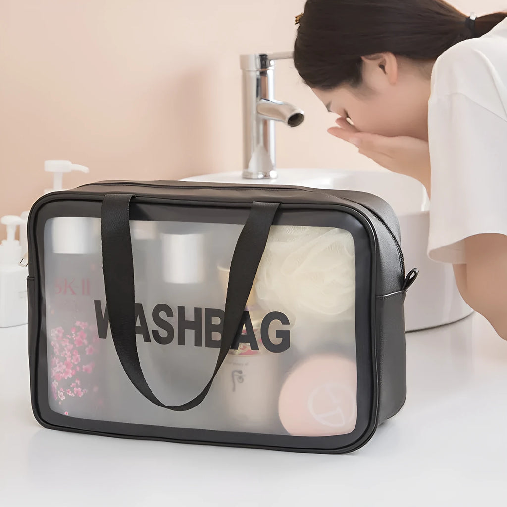 Korean transparent PU waterproof cosmetic bag in cherry pink, medium size, on a white background, showing its cube shape and zip closure.