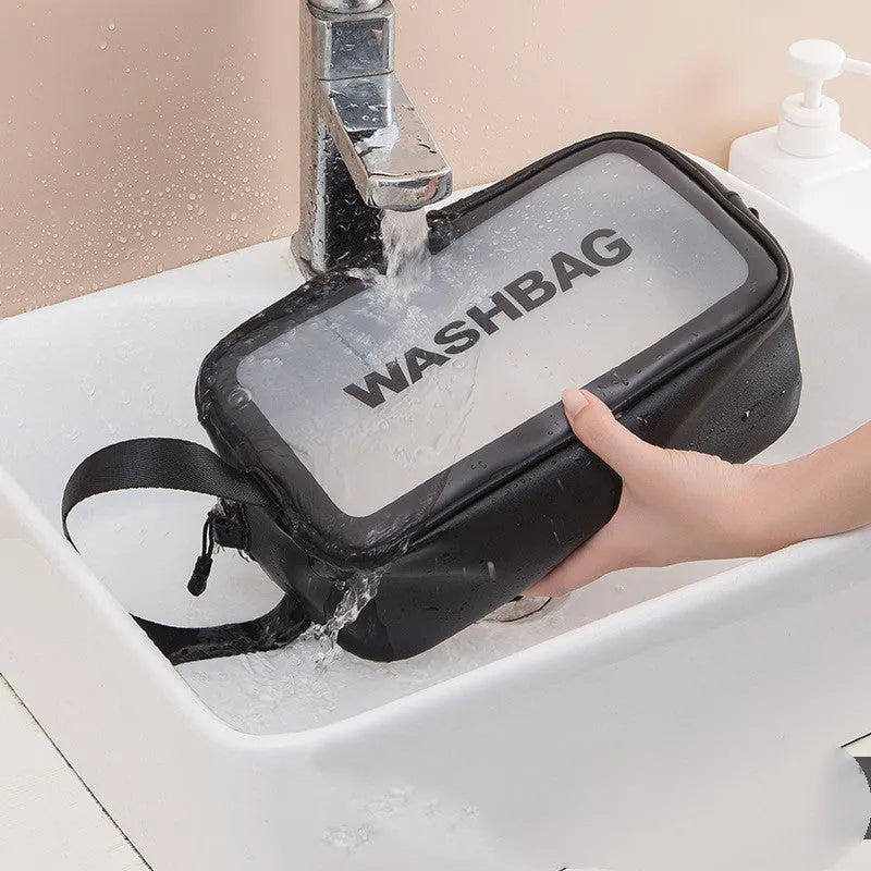 Korean transparent PU waterproof cosmetic bag in cherry pink, medium size, on a white background, showing its cube shape and zip closure.