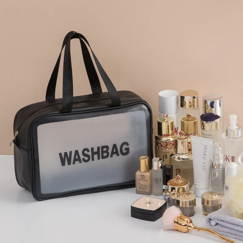 Korean transparent PU waterproof cosmetic bag in cherry pink, medium size, on a white background, showing its cube shape and zip closure.