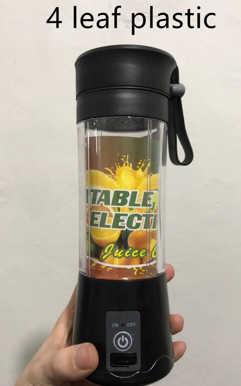 Mini USB-powered handheld fruit juicer with green plastic housing and a stainless steel blade.