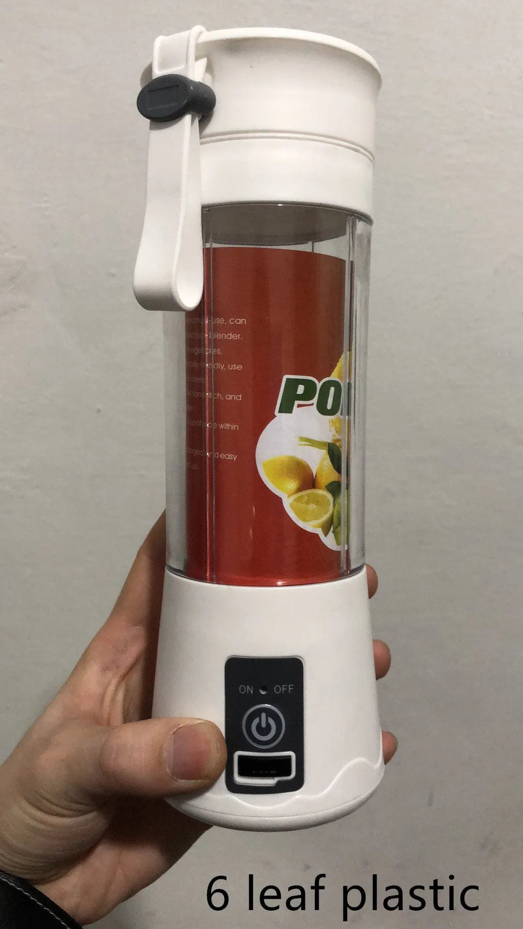 Mini USB-powered handheld fruit juicer with green plastic housing and a stainless steel blade.
