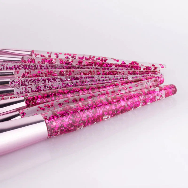 10 makeup brushes with pink powder-filled handles and nylon bristles arranged in a fan shape