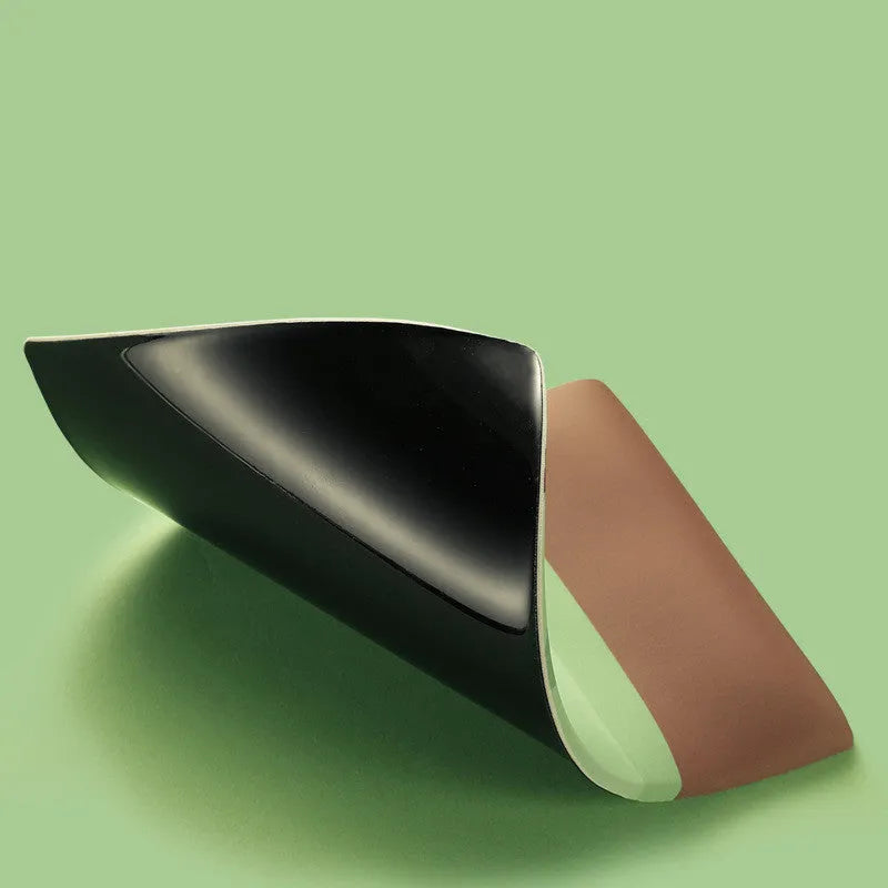 Green kiwi fruit shaped mouse pad with integrated soft wrist support cushion on a desk.
