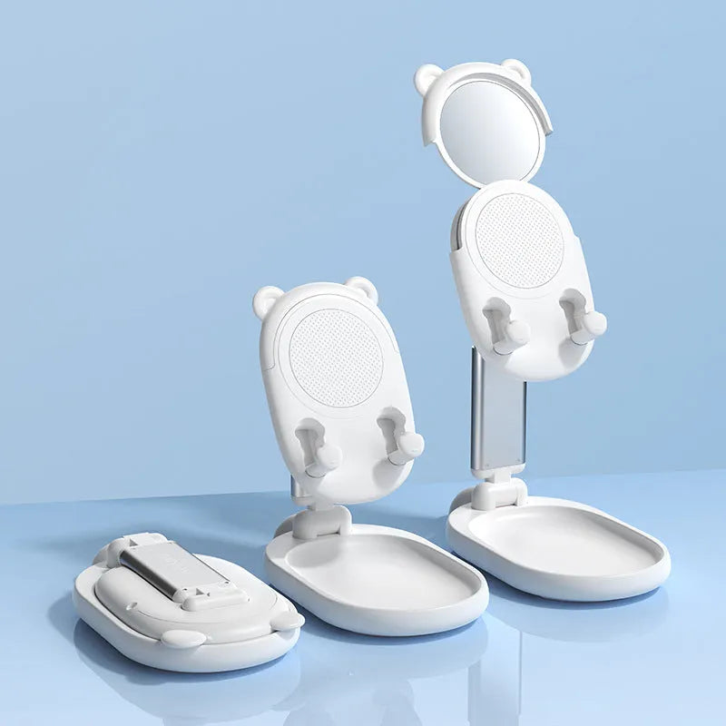 Adjustable blue desk stand holding an iPhone, showing its built-in mirror and foldable design.