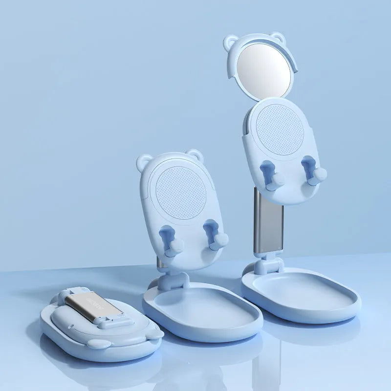 Adjustable blue desk stand holding an iPhone, showing its built-in mirror and foldable design.
