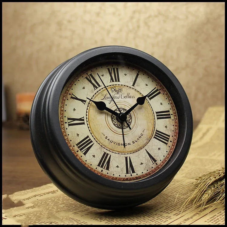 Round retro-style 6-inch desk alarm clock with a plastic case on a wooden surface.