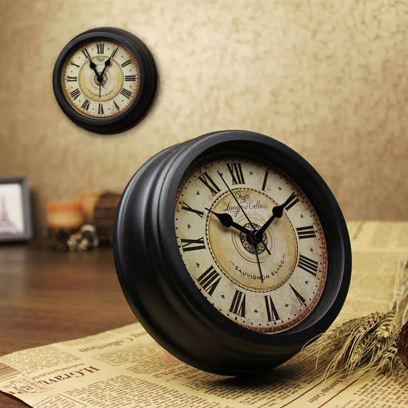 Round retro-style 6-inch desk alarm clock with a plastic case on a wooden surface.