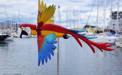 Parrot-themed garden windmill decoration with vibrant colours, spinning in the breeze