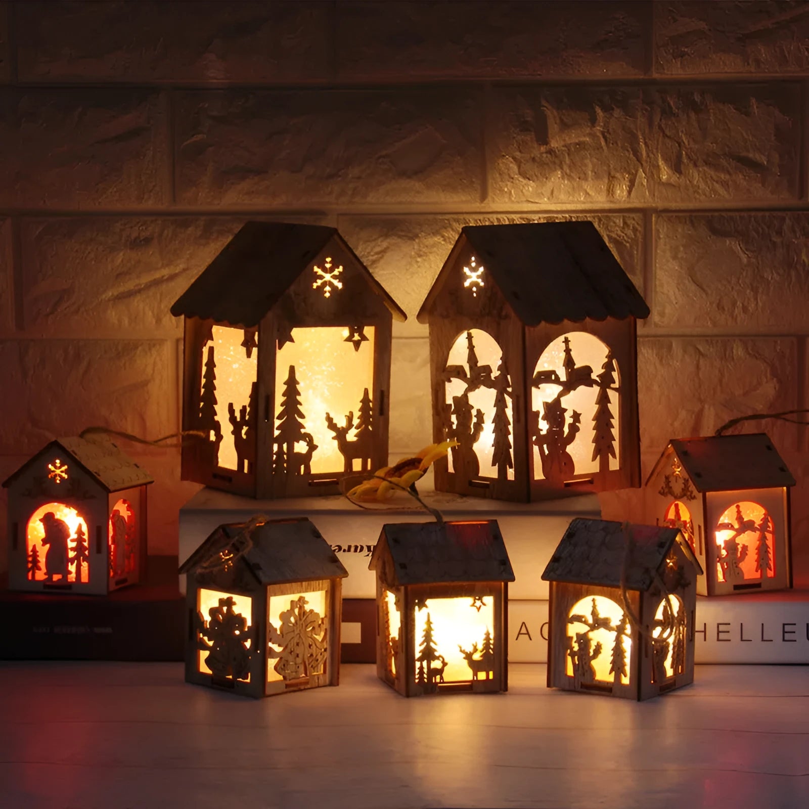 Three wooden Christmas house decorations showing log bell, Santa house, and snowman designs in natural wood colour