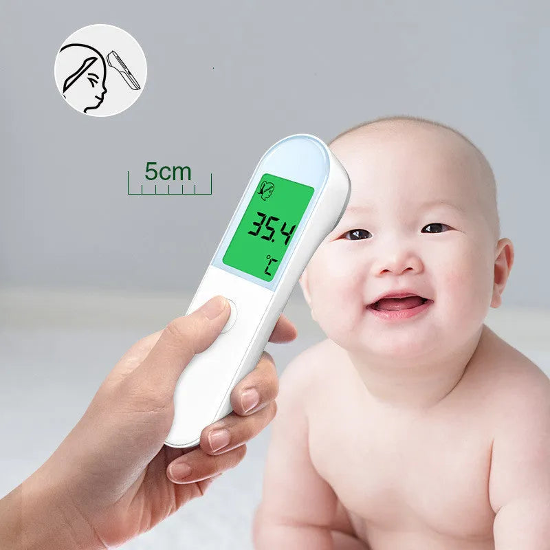 White intelligent non-contact electronic forehead thermometer temperature gun on surface
