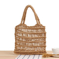 Women's woven straw beach bag with square design and soft handles in natural colour