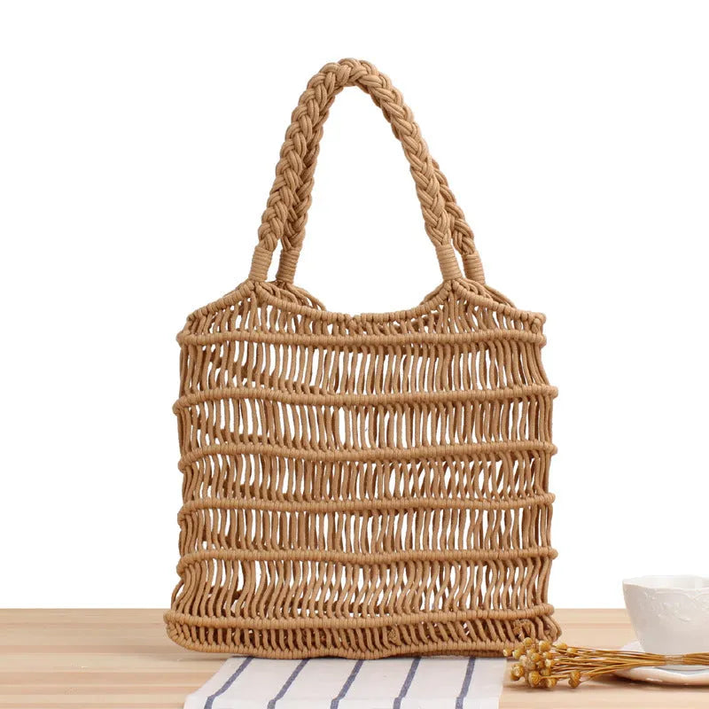 Women's woven straw beach bag with square design and soft handles in natural colour