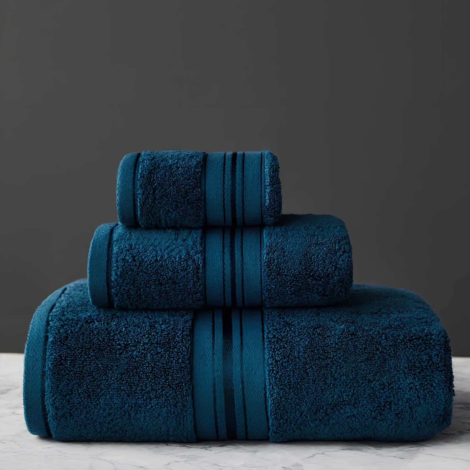 Three-piece cotton bath towel set in blue, featuring 70x150cm bath towel, 34x75cm hand towel, and 34x35cm square scarf for absorbent drying