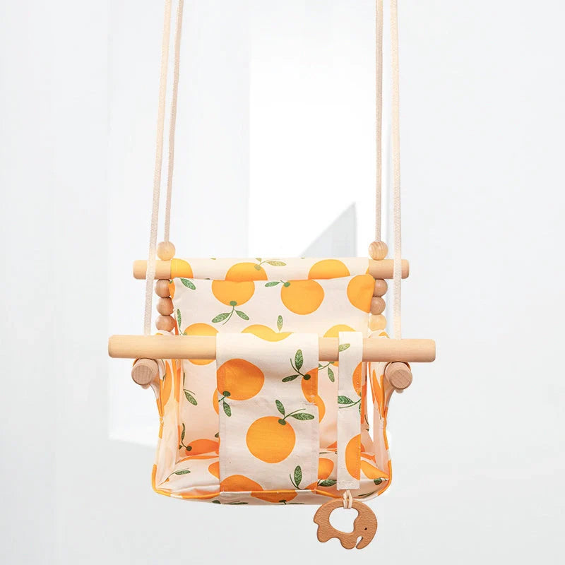 Bohemian style baby swing chair with wooden seat and cotton rope, perfect for indoor and outdoor use.