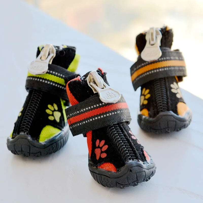 Pair of printed suede dog shoes in green with non-slip sole for medium and large dogs on a white background