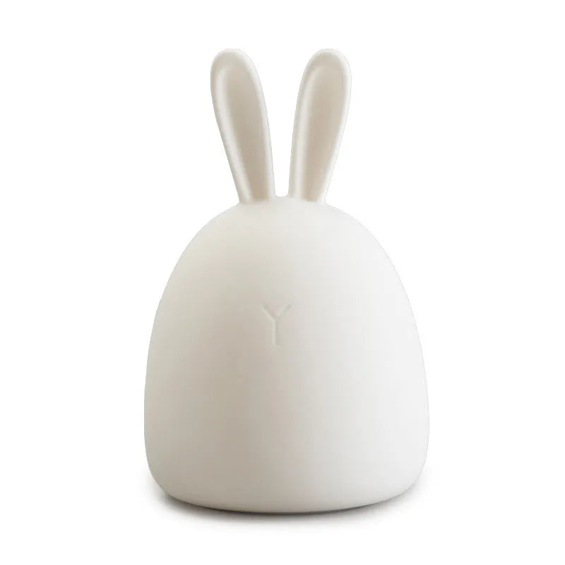 White fat rabbit silicone lamp with touch switch and charging base on a plain background