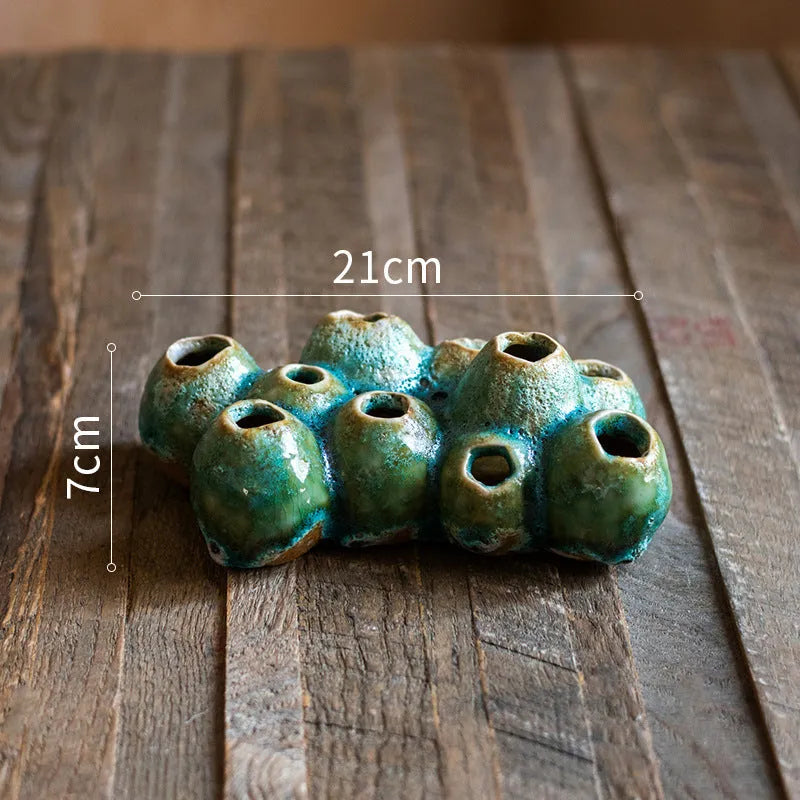 Medium ceramic barnacle vase with porous texture in new Chinese style, shown on a table.