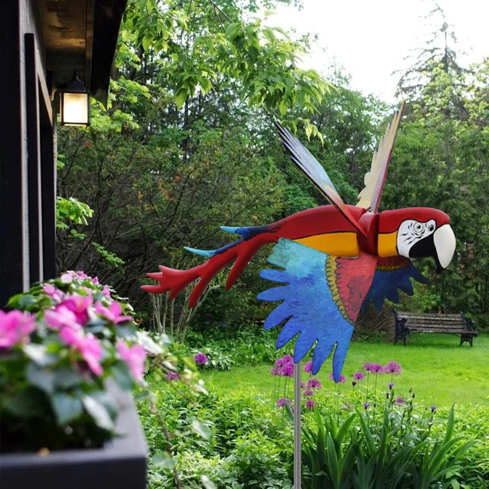 Parrot-themed garden windmill decoration with vibrant colours, spinning in the breeze