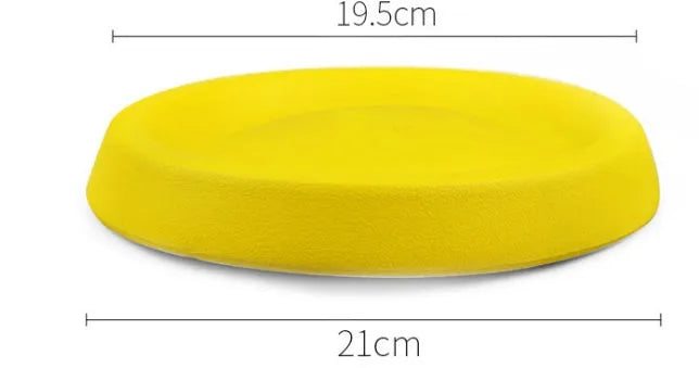 Yellow lightweight EVA dog throwing toy on grass for outdoor fetch play