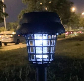 Small white and purple solar-powered mosquito killer lamp for outdoor garden and camping use.